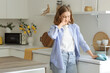 © Pixel-Shot - Young woman suffering from dust allergy while cleaning kitchen