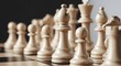 © Khasani - Close-up perspective of white chess pieces lined up for a game on a classic checkerboard, a concept for strategy and tactics