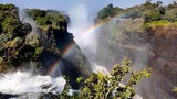 Victoria Falls In Livingstone Northern Rhodesia Zambia. Powerful Waterfall Cascading Over Rocky Cliff Into Mist. Landscape Dramatic Sky Waterfall Tropical. Landscape Waterfall Panoramic.