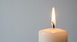 © Lucas - Zachte kaarsvlam gloeit helder tegen neutrale achtergrond. AI Generated