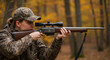 © Vyatcheslav - Woman aiming rifle while hunting in autumn forest