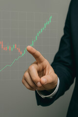 Poster - Financial Ascent: A businessperson's finger traces a digital chart indicating financial growth, illustrating the dynamic progress and upward trajectory of investments.