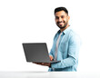 © Md. Mozammel Hoq - An attractive Indian man smiling and using a laptop on a white table, isolated on transparent background.