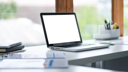 Wall Mural - Open laptop with blank white screen on a modern office desk, for mockup, web design.