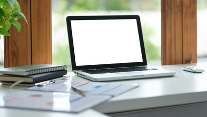 Wall Mural - Open laptop with blank white screen on a modern office desk, for mockup, web design.