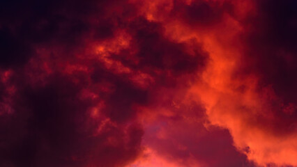 red cloudy mystical sky. artistic photo of clouds illuminated by setting sun. background dramatic su