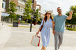 © BGStock72 - Couple enjoying a sunny day while shopping in a vibrant outdoor mall