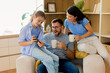 © BGStock72 - Family bonding moment in a cozy living room with laughter and joy
