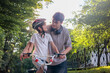 © Светлана Мищенко - Teenage brother helps his younger sibling learn to ride a bike with training wheels on a sunny summer day. Family bonding, support, childhood development, outdoor fun and learning. Copyspace.