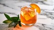 © Judith - crodino spritz amber elixir a refreshing cocktail with ice cubes orange slice and green leaves in a clear glass on a marble surface