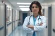 © Anna - Confident female doctor in hospital hallway