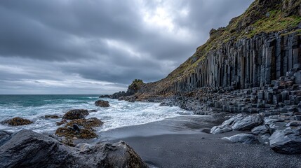 Wall Mural - a rocky beach adjacent to a cliff on a cloudy day, featuring waves crashing against the shore and th