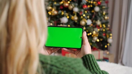 Woman using phone green screen christmas