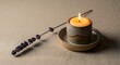 © Luan - Still life featuring a lit candle in a ceramic holder with lavender on a textured surface