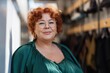 © Andrii Zastrozhnov - Smiling caucasian mature female with red hair and glasses in green dress