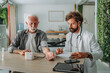 © Miljan Živković - Doctor measuring blood pressure of senior patient in medical office