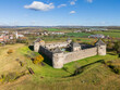© AmazingAerialAgency - Aerial view of the medieval BzovÃ­k Monastery stands in stark contrast to the modern village beyond, a testament to time's passage, BzovÃ­k, Krupina, Slovakia.