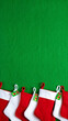 © MorshedBD2 - Festive Christmas Stockings Hanging on a Vibrant Green Wall Ready for Holiday Cheer and Gifts with Family and Friends