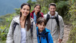 © Kliapko_Photo - Latin American family hiking up a mountain trail, wearing practical clothing and enjoying nature.