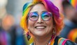© Aarti - Candid pride close-up of a happy mature plus-size queer Asian woman with colorful hair smiling and celebrating the gay pride festival, Generative AI