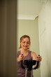© Cavan - Home fitness workout, woman training on stationary bike indoors