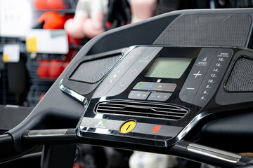 Modern treadmill console with digital display monitor screen. Sport equipment for indoor running training in sport shop