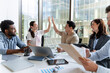 © Maria Vitkovska - Marketing team celebrating good results giving high five during a meeting