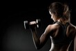 © Arfa_Media - Young sportswoman lifting weights during strength training, showcasing determination and strength against a striking black background