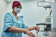 © Georgii - Medical professional washing hands in a clinical setting for hygiene compliance