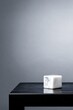 © Dian - Sleek, minimalist cube of white marble on a dark, polished surface