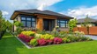© Mary - Brightly colored garden enhances modern house design with lush landscaping and clear blue sky in the background