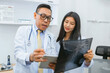 © lovelyday12 - doctor and  nurse are looking at  medical image of  patient's spine