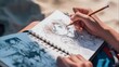 © Imanberlina - Close-up of a hand holding a pencil. An artist draws an anime comic on vacation, on the beach. Manga. Anime