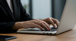 © Mubarak - Close-up of a Businesswoman's Hands Typing on a Laptop Keyboard, Symbolizing Focused and Productive Work in a Modern Office