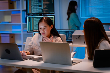 asian software engineer or programmer team working late in development office,problem solving or alg