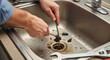 © Cliff - Plumber cleaning clogged drain of dirty sink drain close-up