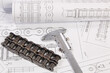 © bayurov - Driving roller chain with a caliper on a paper engineering drawings