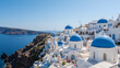 © Rachel - Oia Santorini's iconic blue-domed churches overlooking the island's volcanic caldera and the Mediterranean Sea