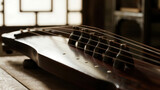 Close-up of a stringed musical instrument with wooden texture and tuning pegs