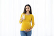 © Anastasiya - Pregnant woman with disgusted expression holding glass of milk, showing food aversion or nausea. Realistic representation of pregnancy symptoms in everyday life, copy space