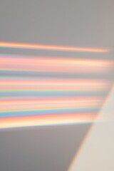 Abstract rainbow light diffraction on wall with soft tones