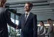 © ASDF - A man in a suit is talking to a man in a suit