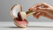 © Tiravad - hand holding blush brush over compact with pink blush