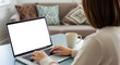 © MdAsiful - Over Shoulder View of Freelancer Woman Working on a Blank Laptop