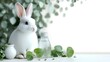 © creative - White rabbit sitting near fresh green leaves and water bottle