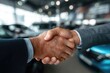 © Alena - Buyer of car shaking hands with seller in auto dealership, view from interior of car. Close-up of handshake of business people. Concept of choosing and buying new car at showroom