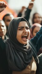 Wall Mural - A young Muslim woman with hijab, yelling and expressing emotion during a protest demonstration. Activism for social justice and civil rights.