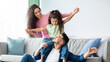 © Prostock-studio - Happy Family Leisure. Cheerful arabic mom, dad and their little daughter having fun at home together, middle eastern parents playing and laughing with child in living room, copy space