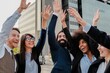 © Vane Nunes - Happy diverse business team celebrating success outdoors in city