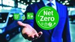© Robert - A male business professional in a blue suit promotes sustainability with a 'Net Zero' graphic, emphasizing eco-friendly practices in logistics and commerce.